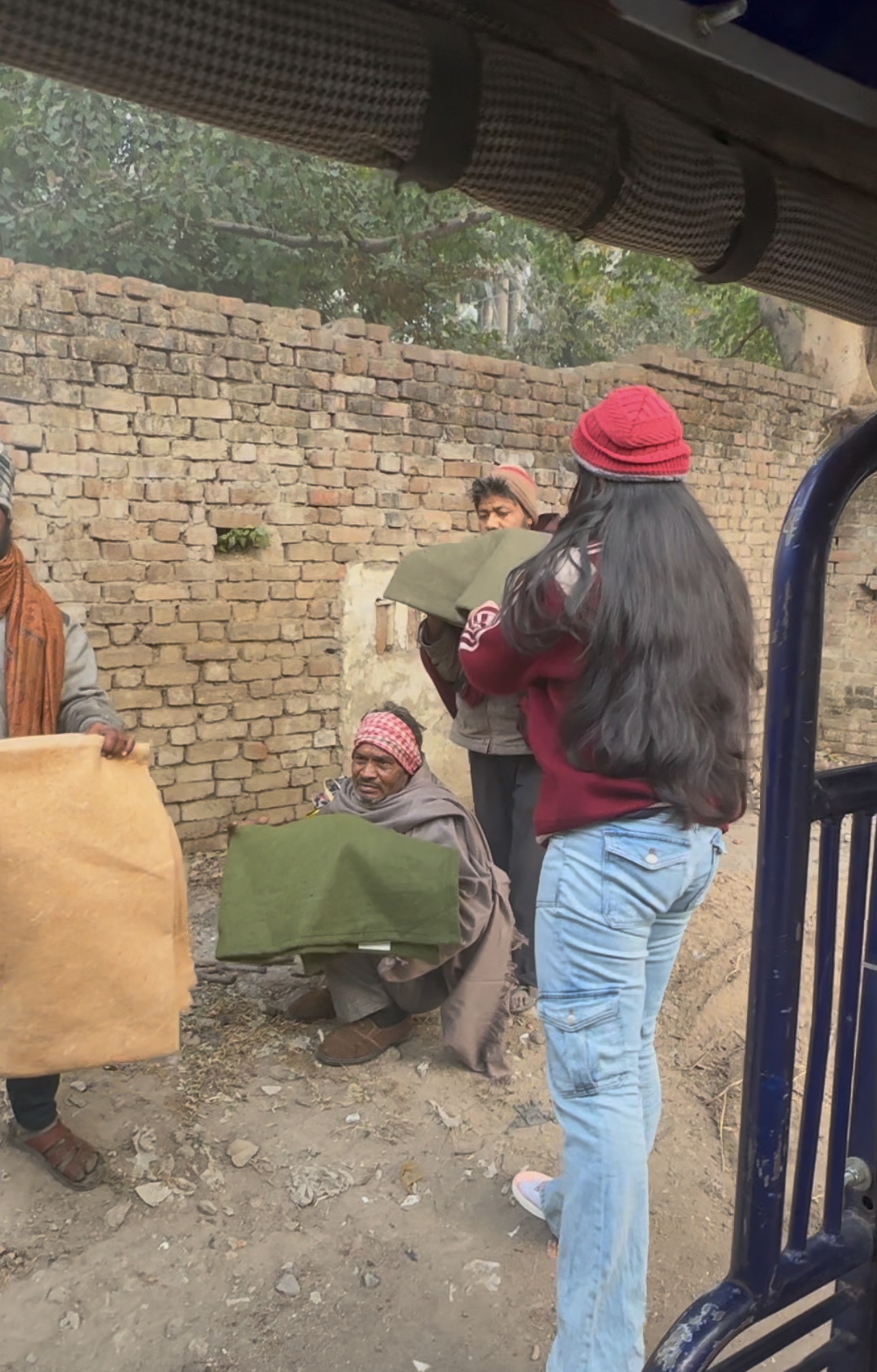 Volunteers distributing blankets to families in India Image #2